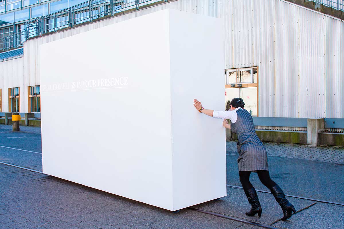 Chun Hua Catherine Dong pushes a big gallery wall during 2010 Winter Olympics in Vancouver, she questions the relationship between artists and galleries