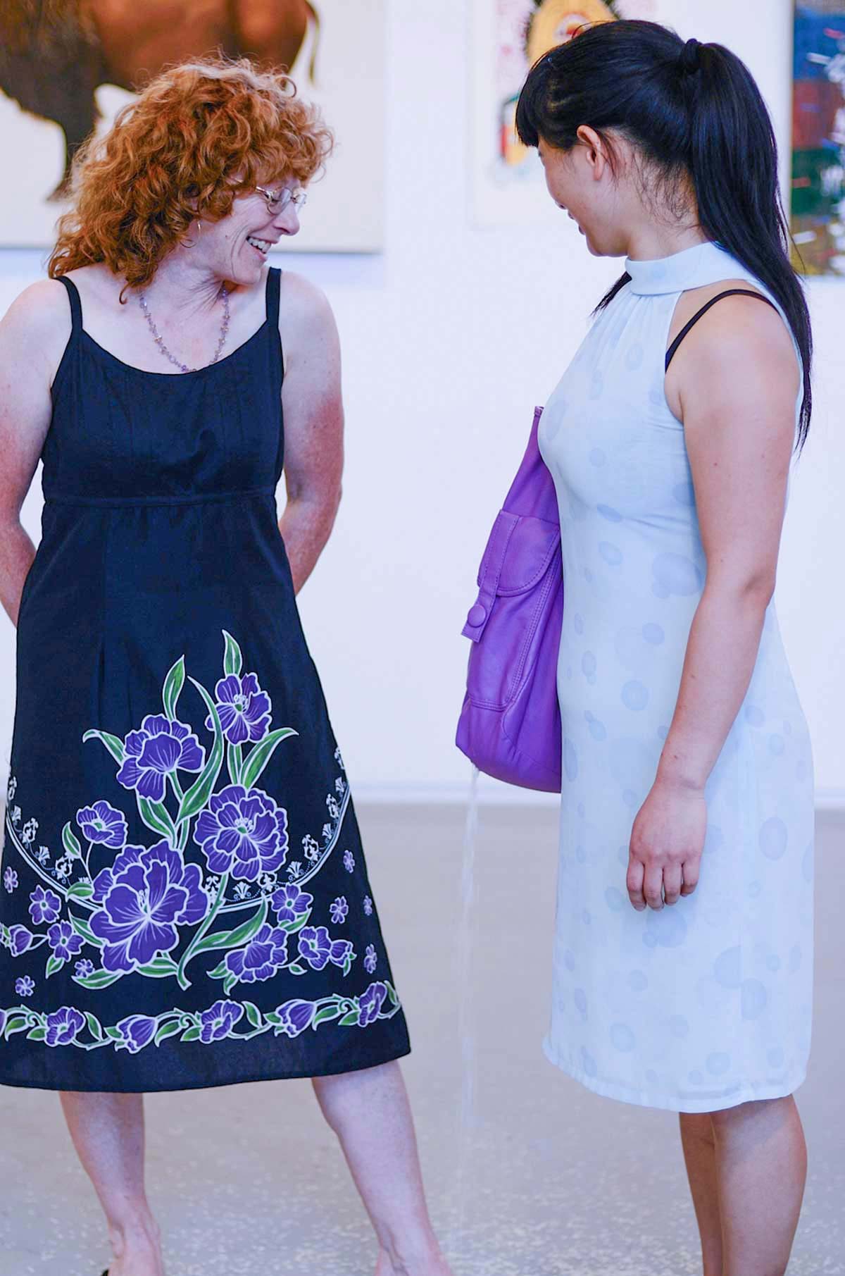 Chun Hua Catherine Dong leaks rice from her bag while having conversation withe people in a gallery in Vancouver. She stops leaking rice when their conversation is over.