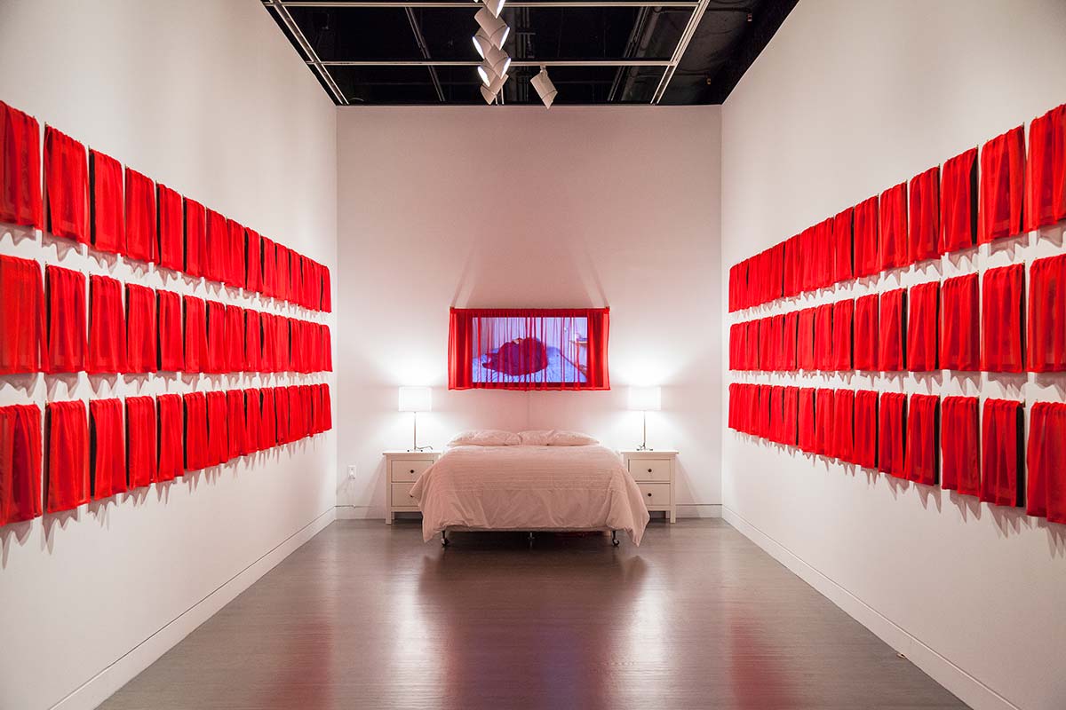 Chun Hua Catherine Dong's work, Husbands and I installation, at Leonard & Bina Ellen Art Gallery in 2012. Chun Hua Catherine Dong covered all of her photographs with red fabric, viewers has to lift up the curtains and see the photographs