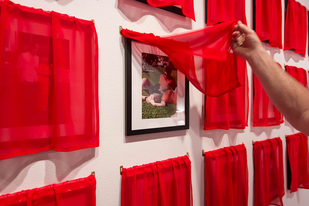 Chun Hua Catherine Dong's work, Husbands and I installation, at Leonard & Bina Ellen Art Gallery in 2012. Chun Hua Catherine Dong covered all of her photographs with red fabric, viewers has to lift up the curtains and see the photographs 