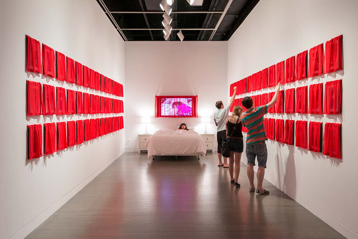 Chun Hua Catherine Dong's work, Husbands and I installation, at Leonard & Bina Ellen Art Gallery in 2012. Chun Hua Catherine Dong covered all of her photographs with red fabric, viewers has to lift up the curtains and see the photographs