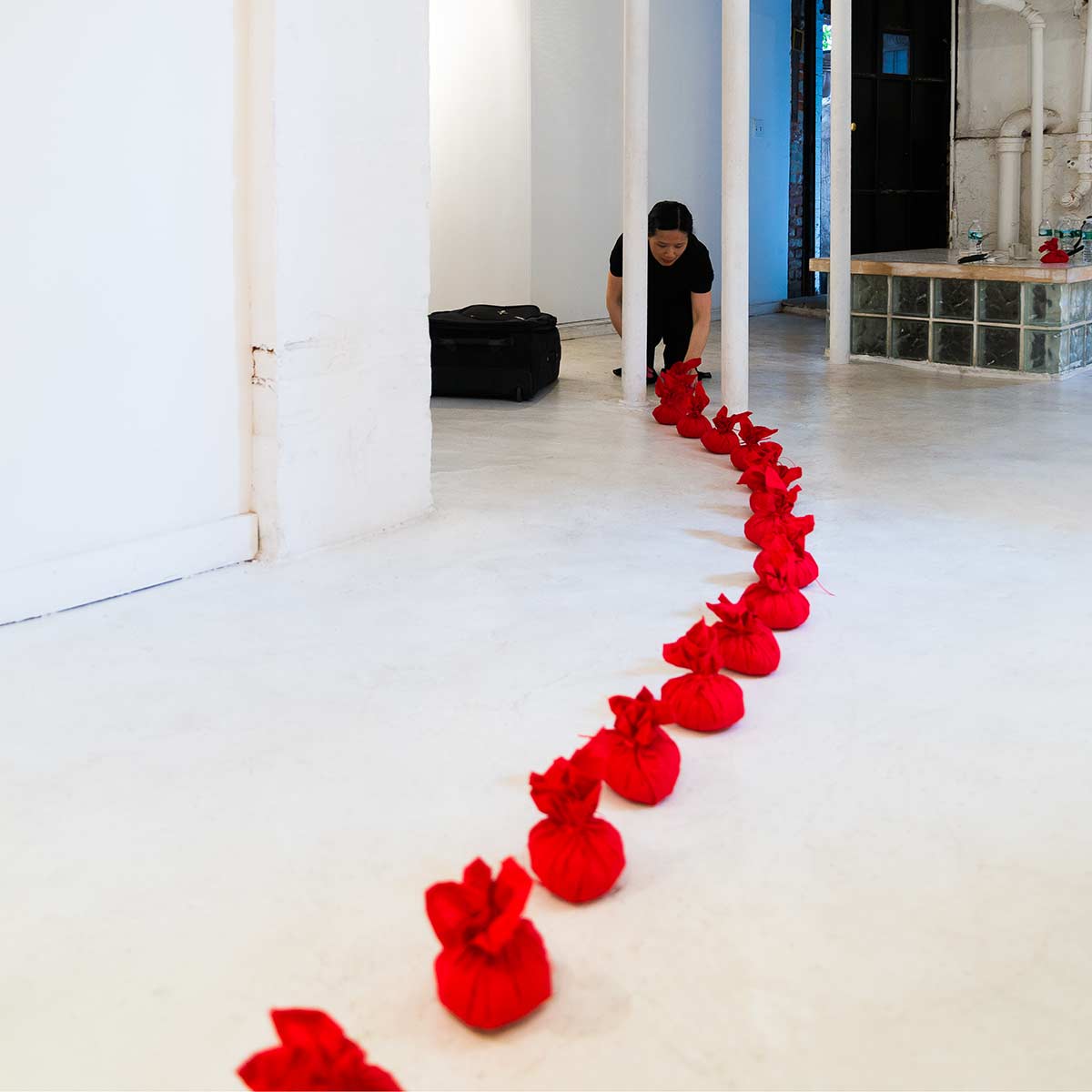 Chun Hua Catherine Dong's performance in New York: she wrapped rice with red handkerchiefs and form them to rice balls, she pressed a rice ball on her forehead and call her name to come home three times with her Chinese dialect