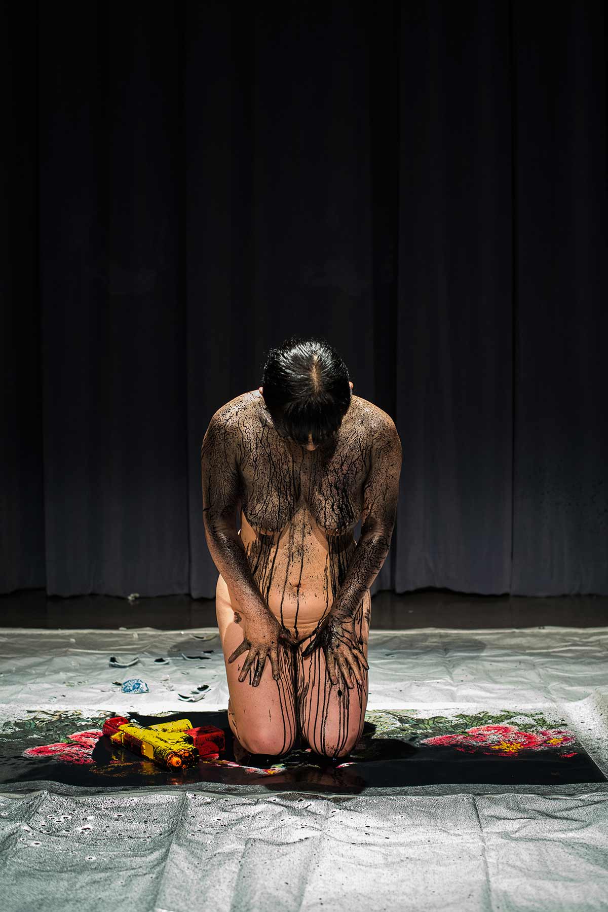 Chun Hua Catherine Dong's performance at MANIFEST! Choreographing Social Movements in the Americas 2014: she kneed on a Chinese painting, her body was full of ink, and she bowed
