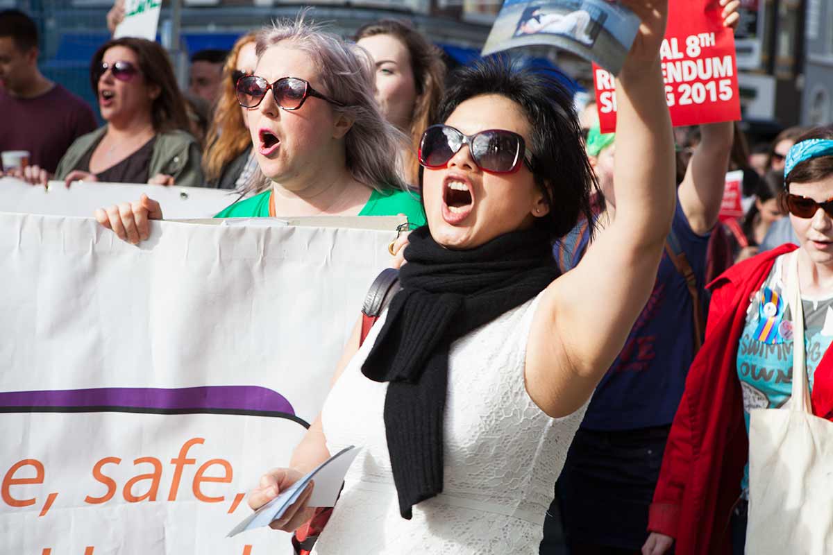 Chun Hua Catherine Dong is at Abortion Rights Campaign Ireland 2014, she held an picture of a woman in a dog cage, and matched with many women to support Abortion Right.