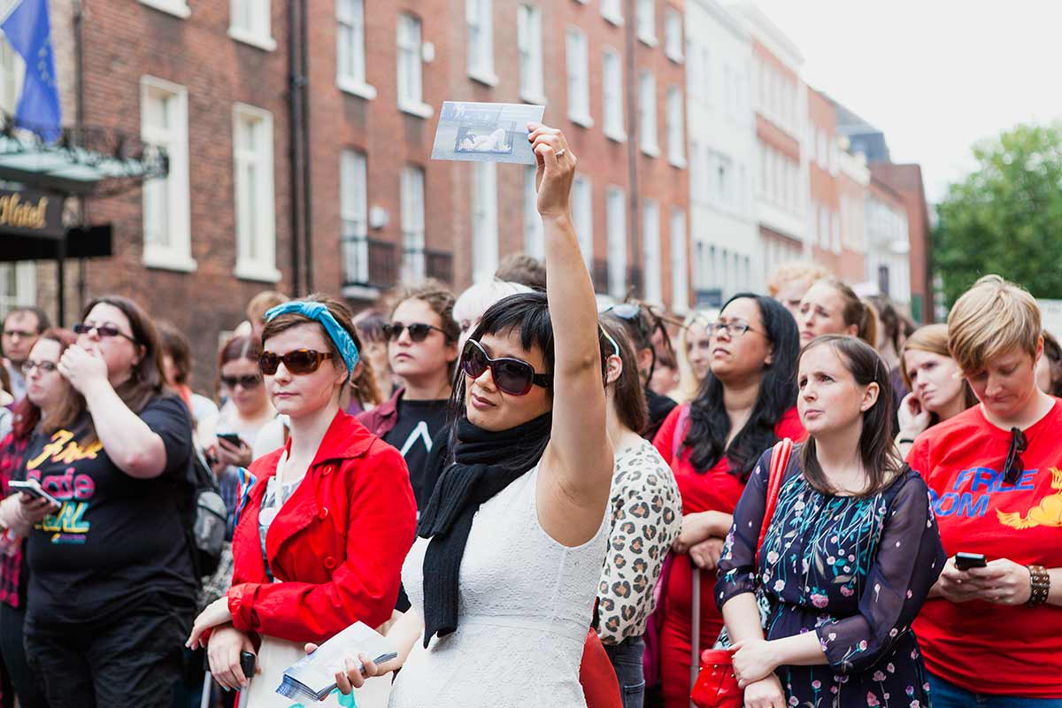 Chun Hua Catherine Dong is at Abortion Rights Campaign Ireland 2014, she held an picture of a woman in a dog cage, and matched with many women to support Abortion Right.