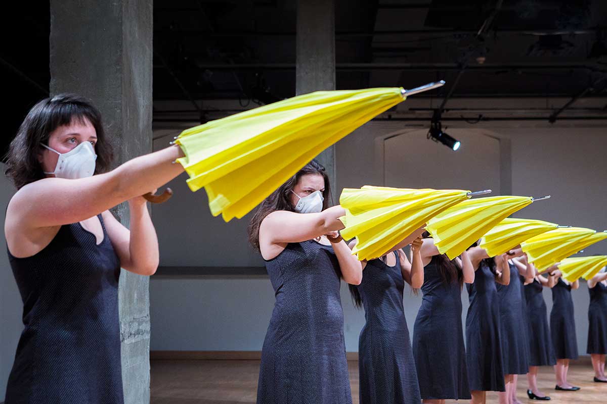 Chun Hua Catherine Dong's Yellow Umbrella performance in Montreal: 12 females point the same direction with their yellow umbrellas