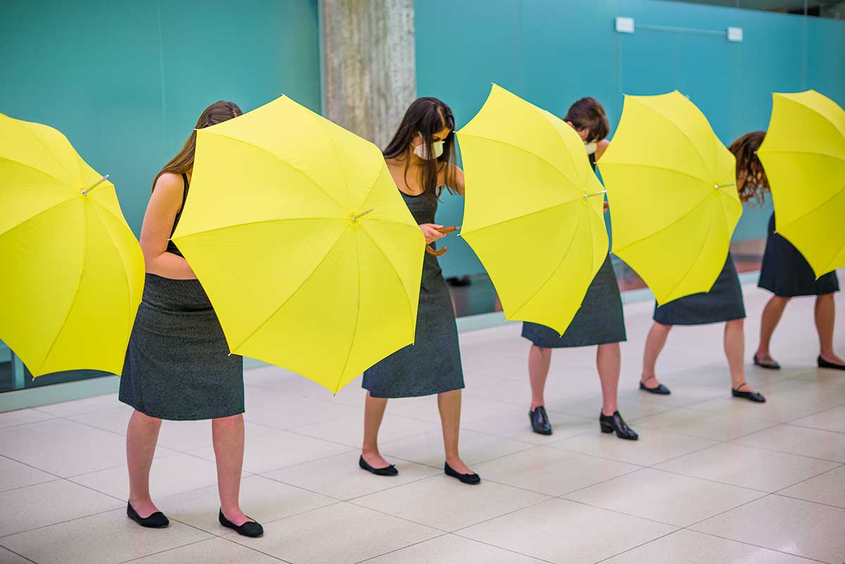 Chun Hua Catherine Dong's Yellow Umbrella performance: 12 females hide behind their umbrellas