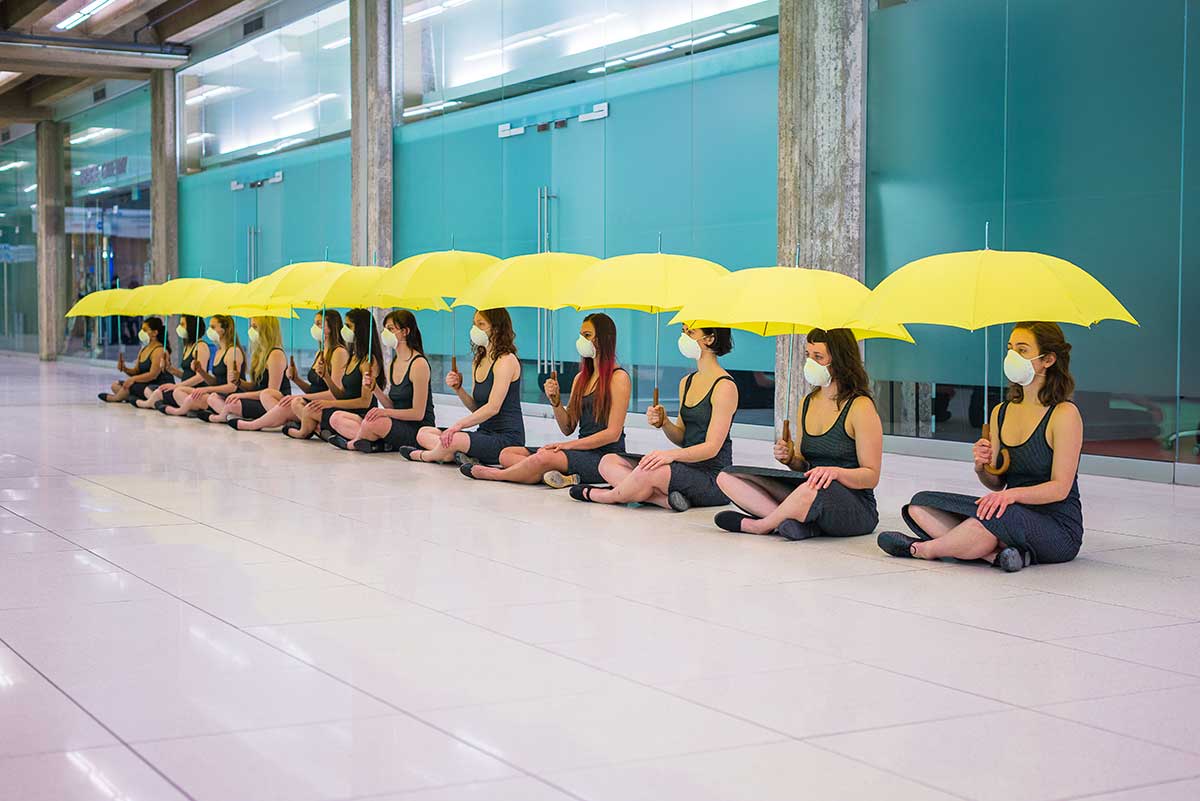 Chun Hua Catherine Dong's Yellow Umbrella performance: 12 females sit on floor to meditate their political situation while holding umbrellas