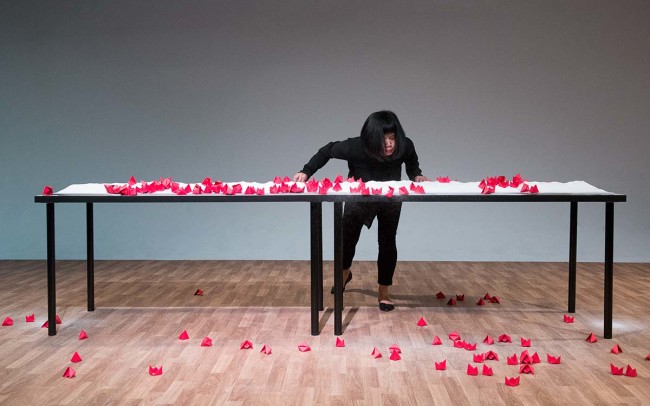 Chun Hua Catherine Dong's performance at 7a11d International Festival of Performance Art in 2016: Dong blows red paper boats to the floor