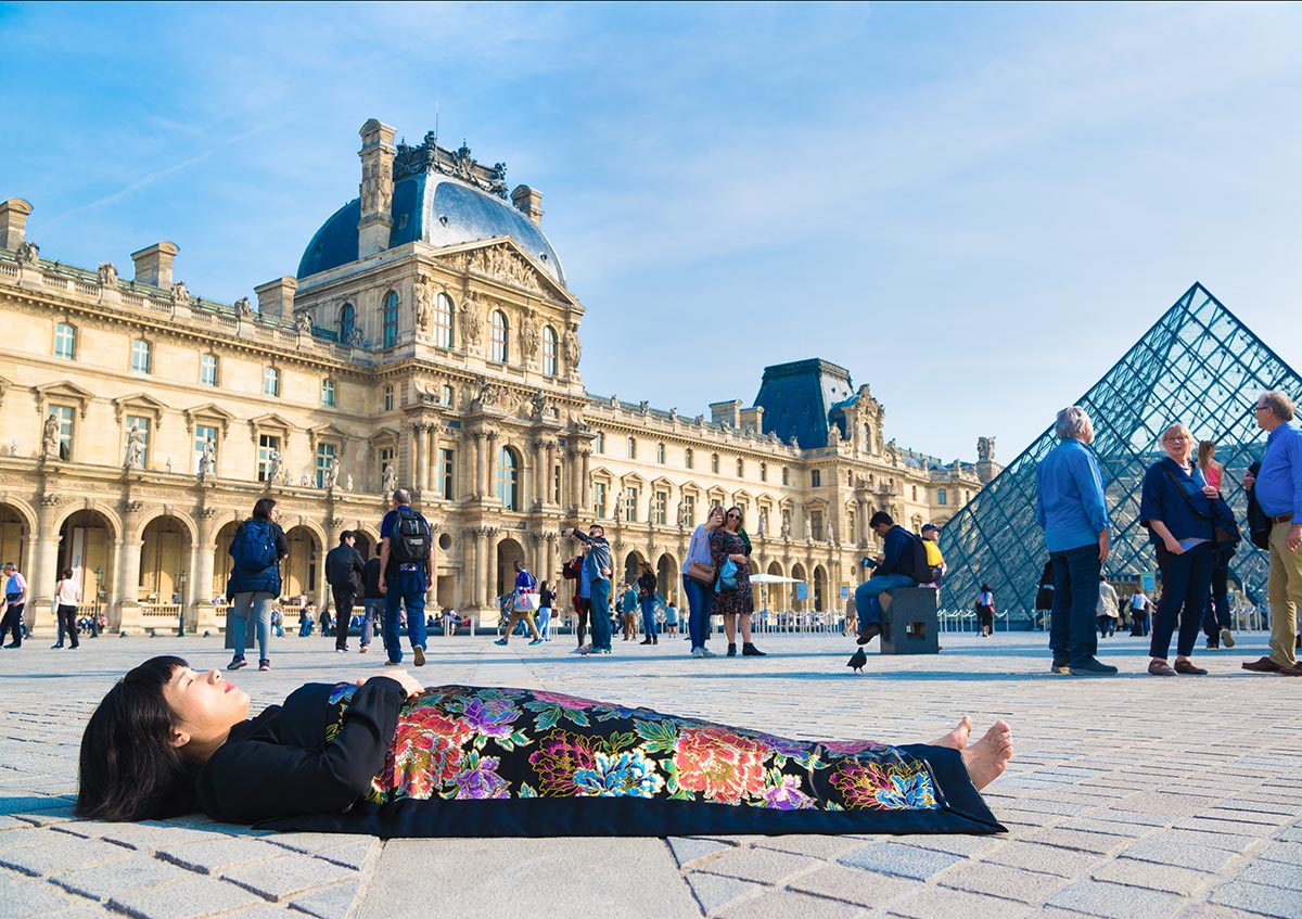 Chun Hua Catherine Dong celebrates her death and buries herself in front of Louvre Paris