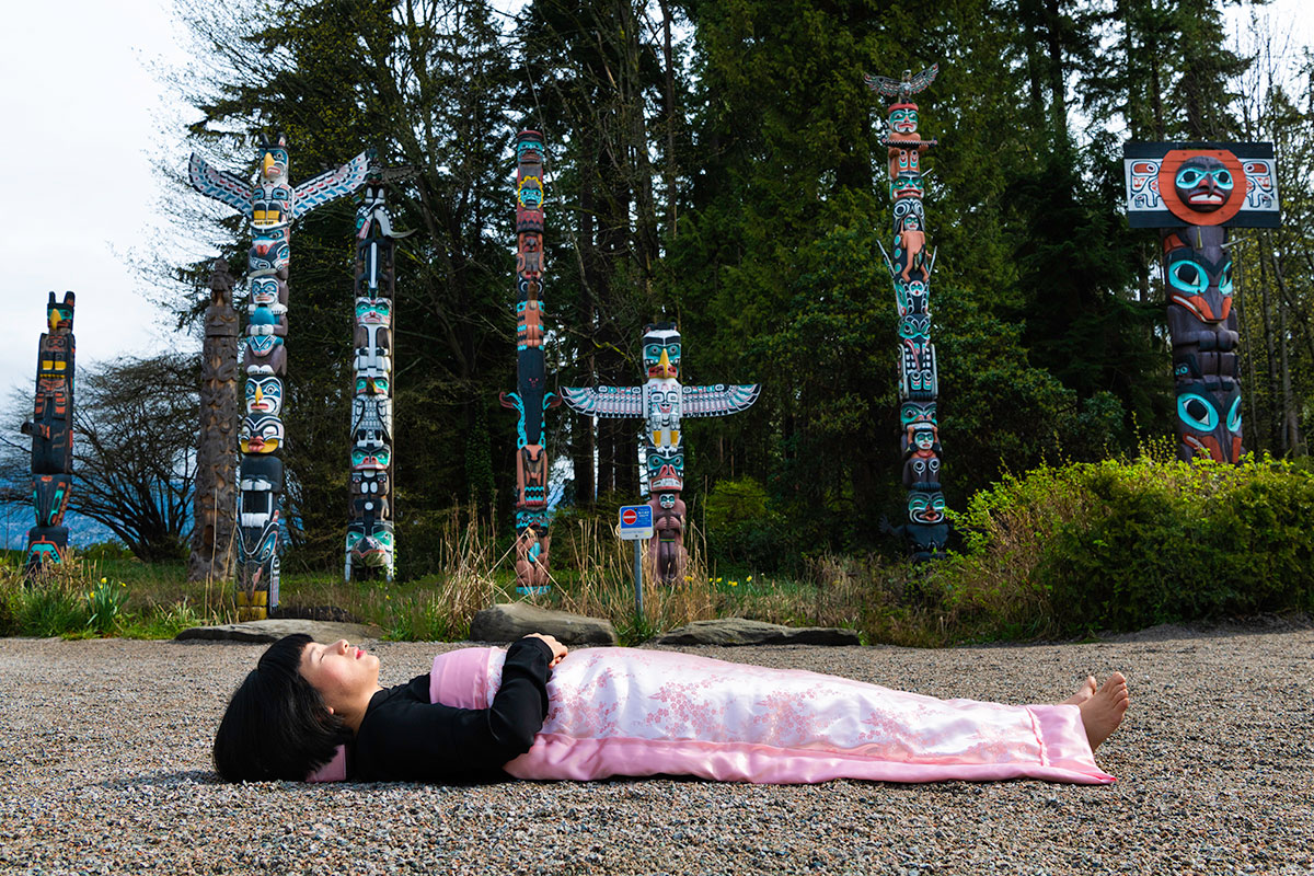 Chun Hua Catherine Dong Lies on ground of Stanley Park Vancouver 