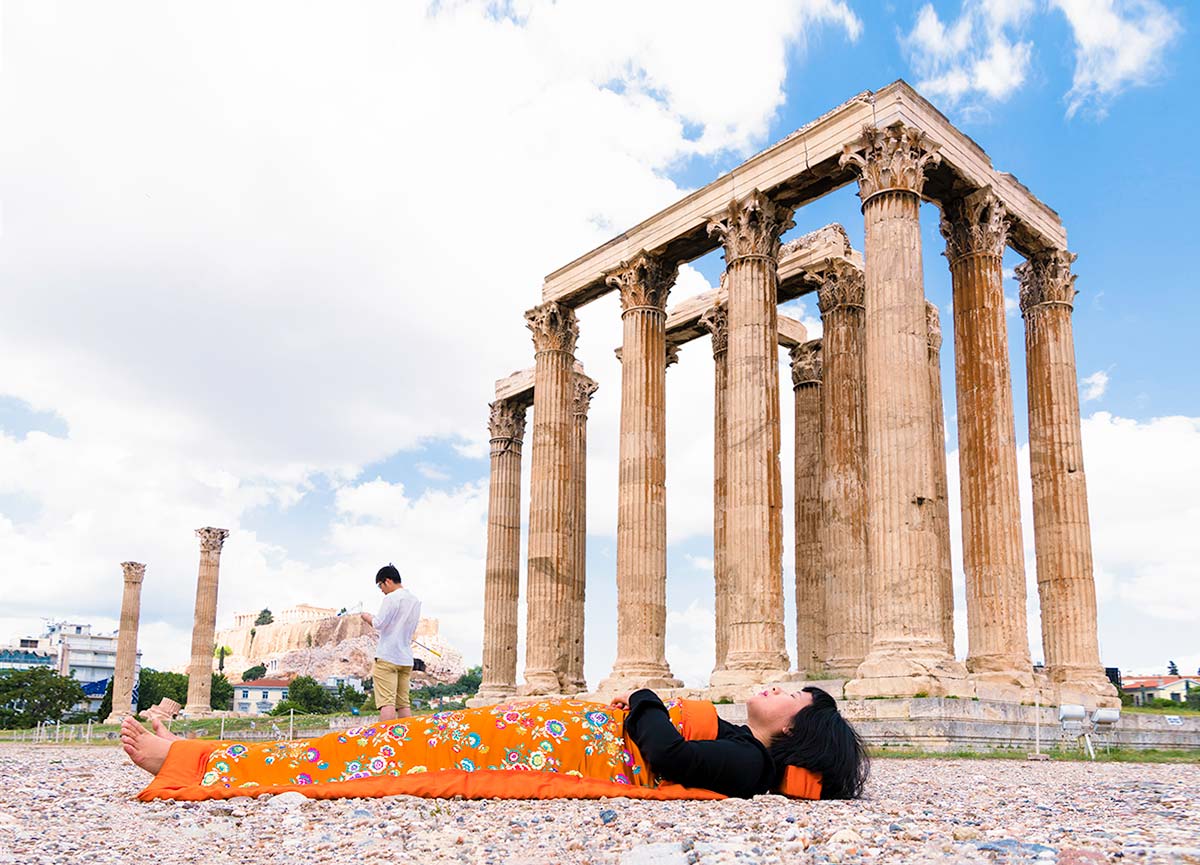 Chun Hua Catherine Dong celebrates her death and sleeps in front of Temple of Olympian Zeus