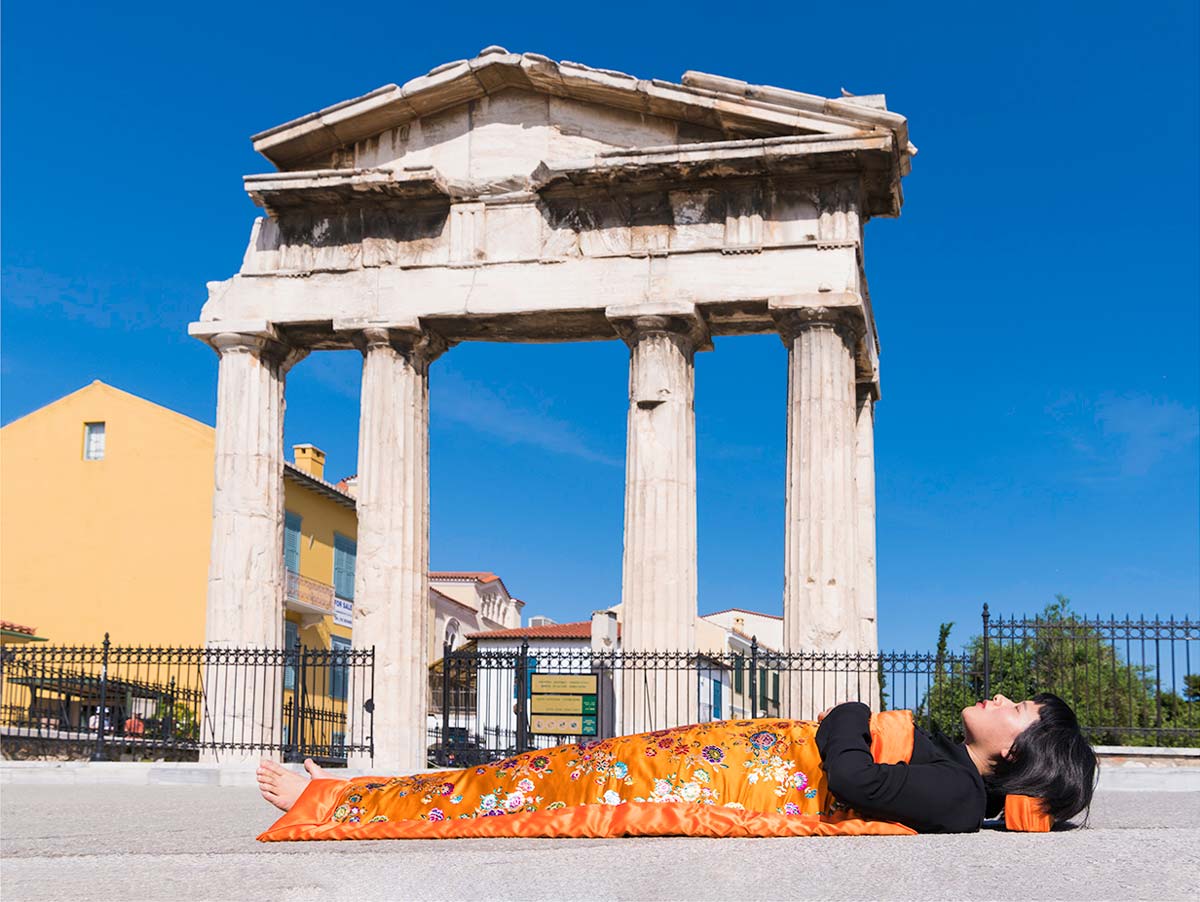 Chun Hua Catherine Dong celebrates her death and sleeps in front  of Arch of Hadrian in Athens
