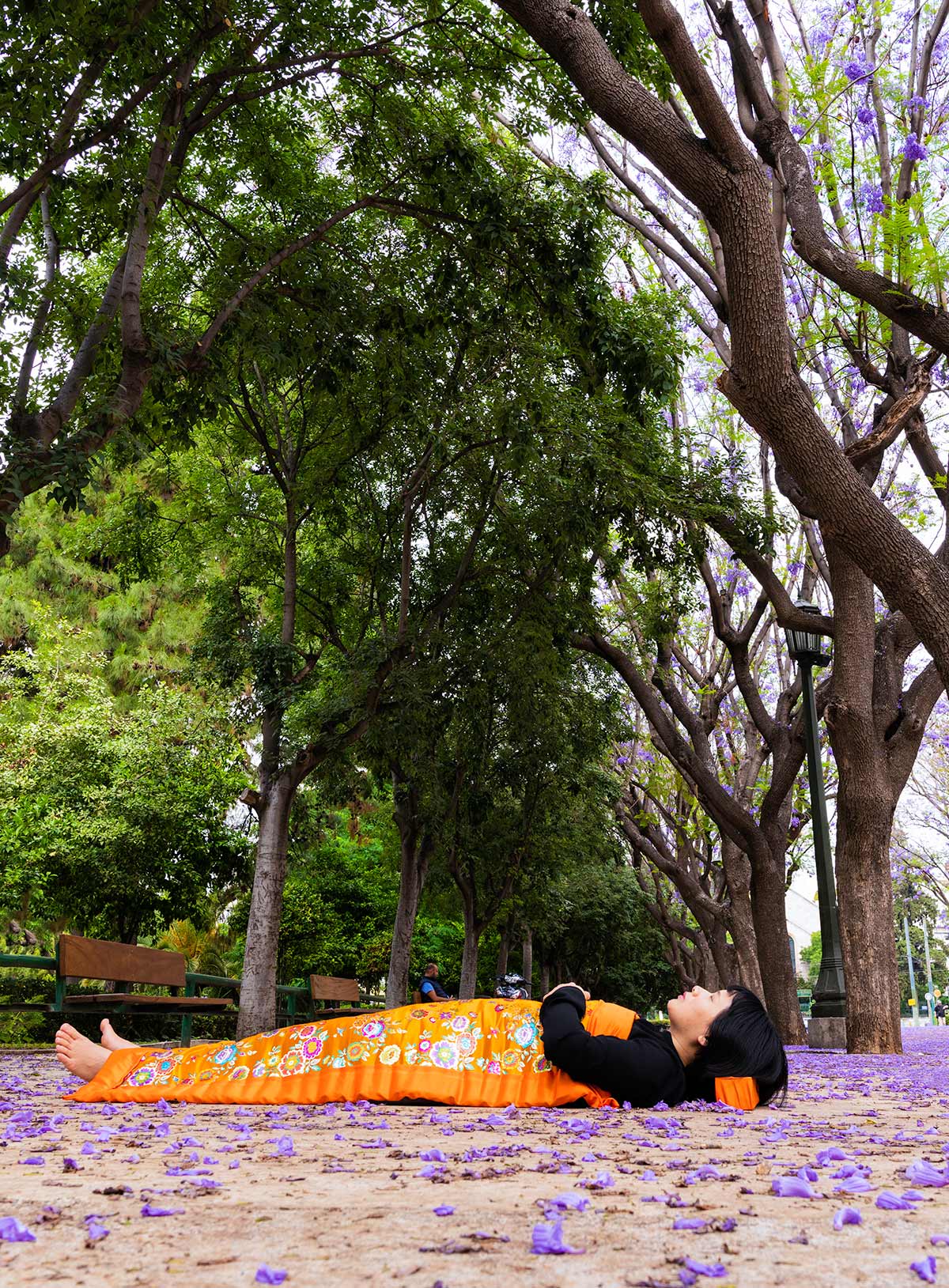 Chun Hua Catherine Dong celebrates her death and sleeps on ground where flowers surround her in Athens