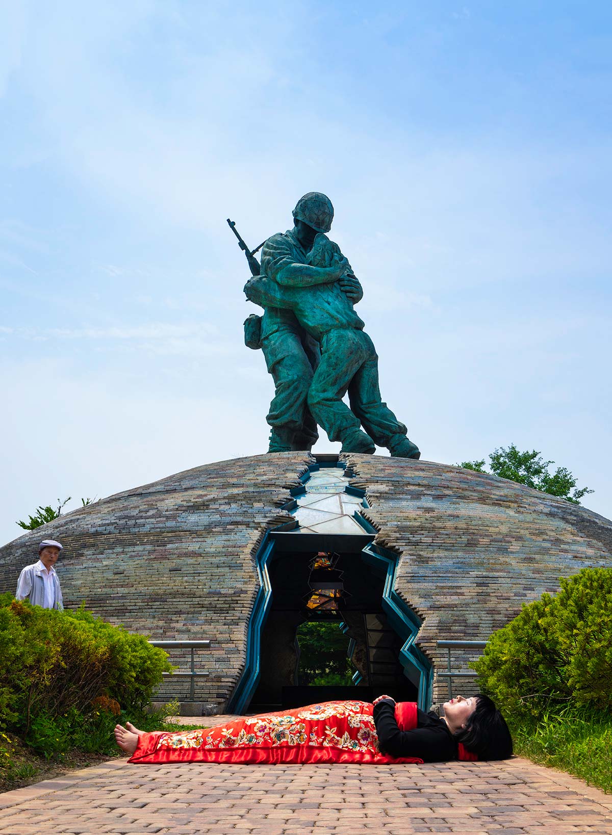 Chun Hua Catherine Dong buries herself with her red corpus cover at War Museum in Seoul