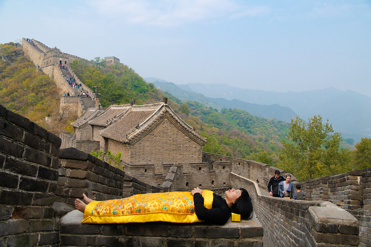 Chun Hua Catherine Dong covers herself with a duvet and performs death ritual at The Great Wall in Beijing.