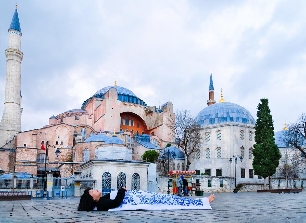 Chun Hua Catherine Dong covers herself with a duvet and performs death ritual in front of Hagia Sophia in Istanbul 