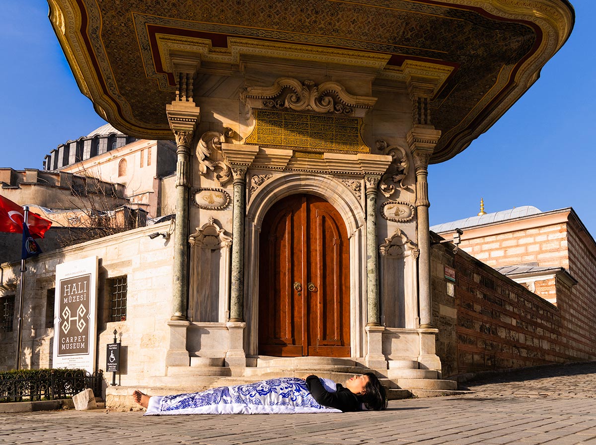 Chun Hua Catherine Dong covers herself with a duvet and performs death ritual  at Hagia Sophia in Istanbul