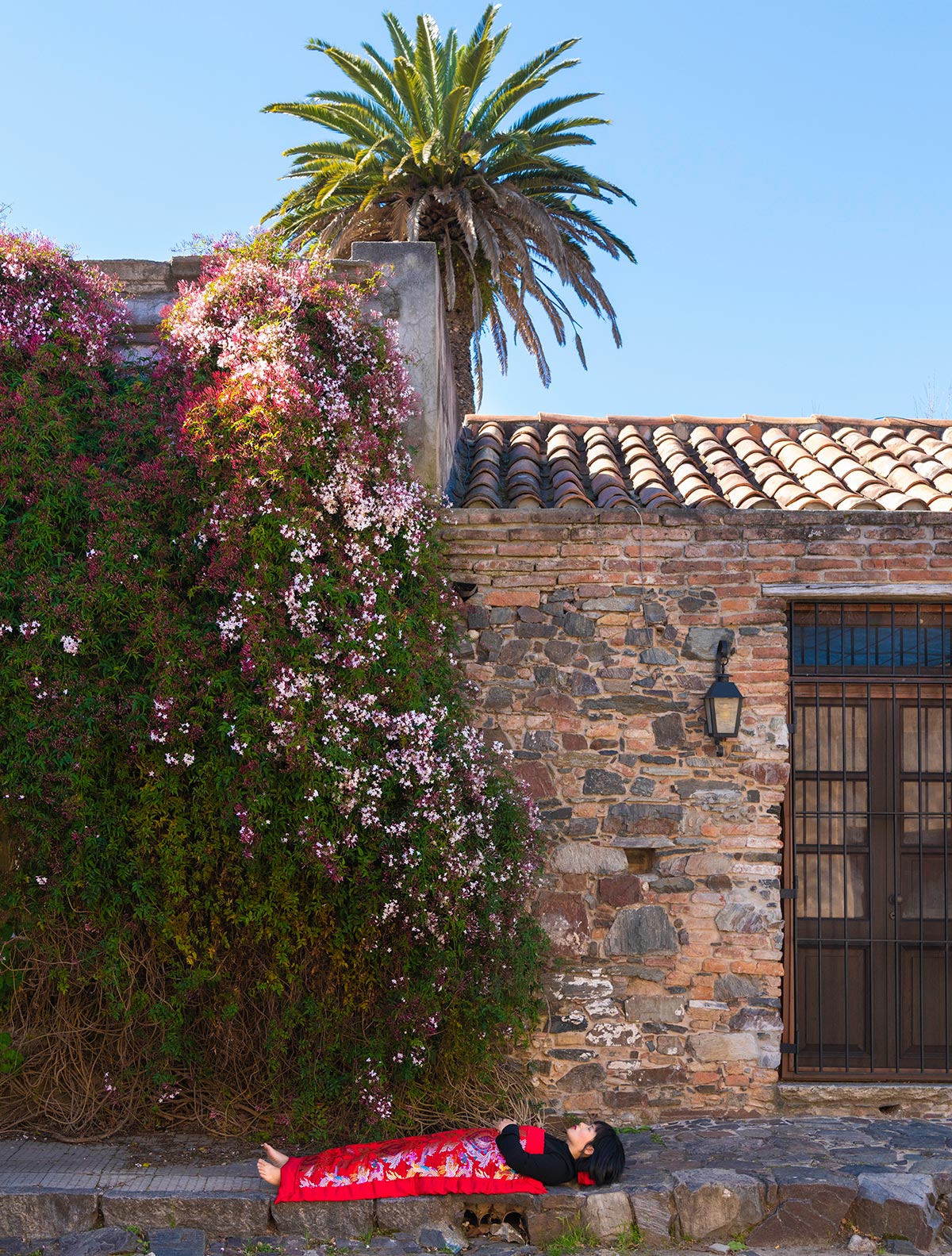 Chun Hua Catherine Dong is with flowers and old houses in Colonia del Sacramento, Uruguay