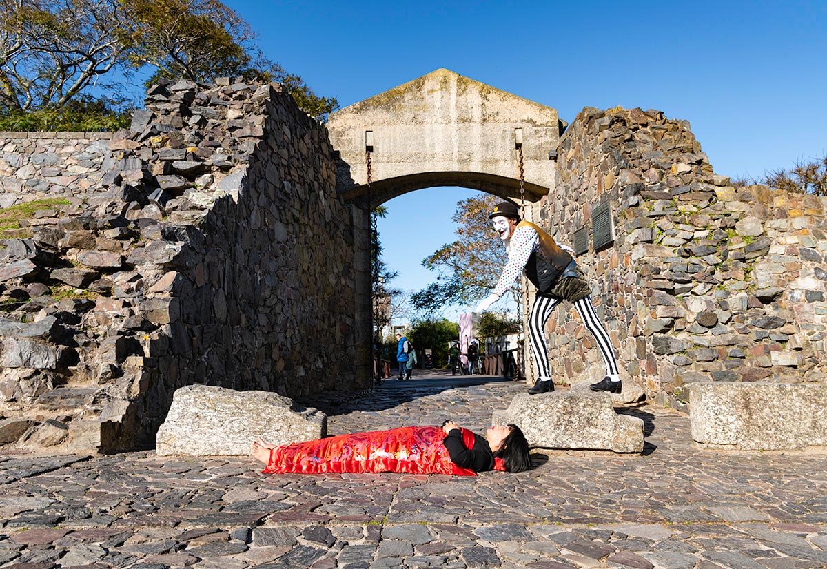 A clown plays magic tricks for Chun Hua Catherine Dong in Colonia del Sacramento, Uruguay