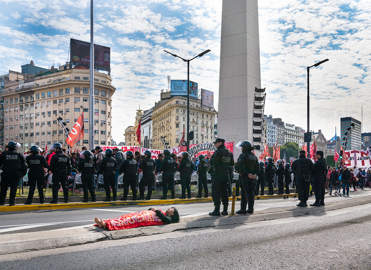 Chun Hua Catherine Dong are with polices in a demonstration in Buenos Aires