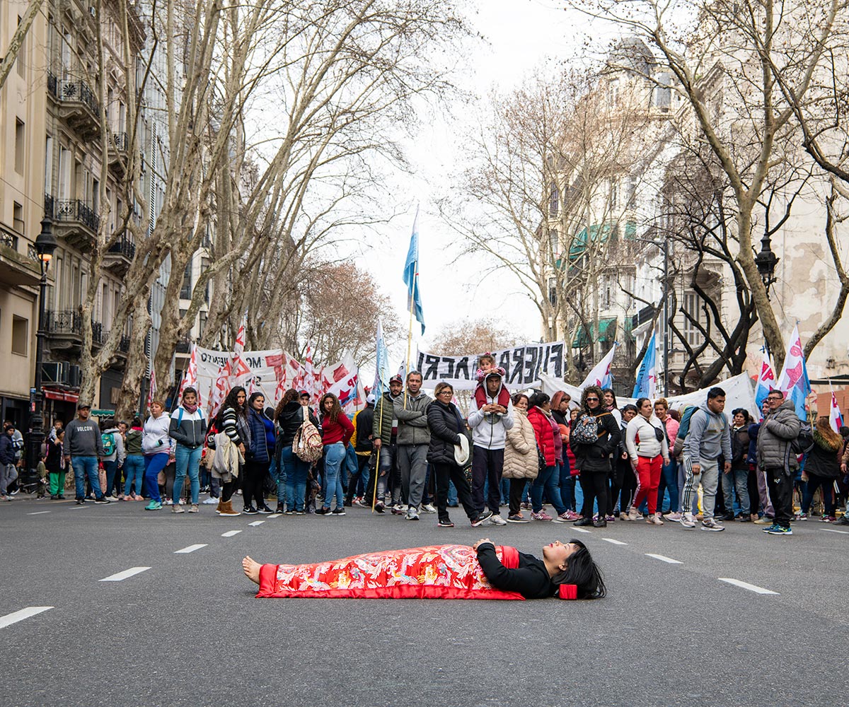 Chun Hua Catherine Dong  sleeps on a demonstration in Buenos Aires