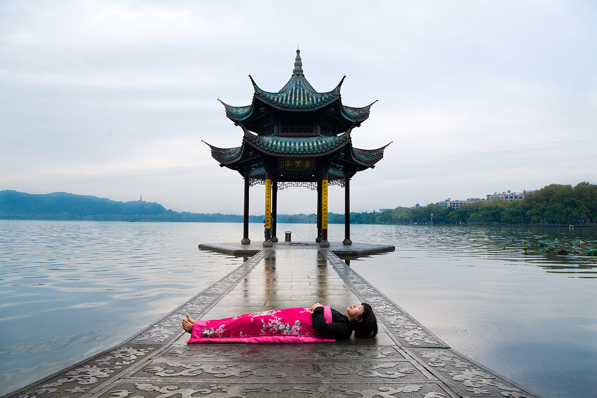 Chun Hua Catherine Dong sleeps at the West Lake in HangZhou, China 