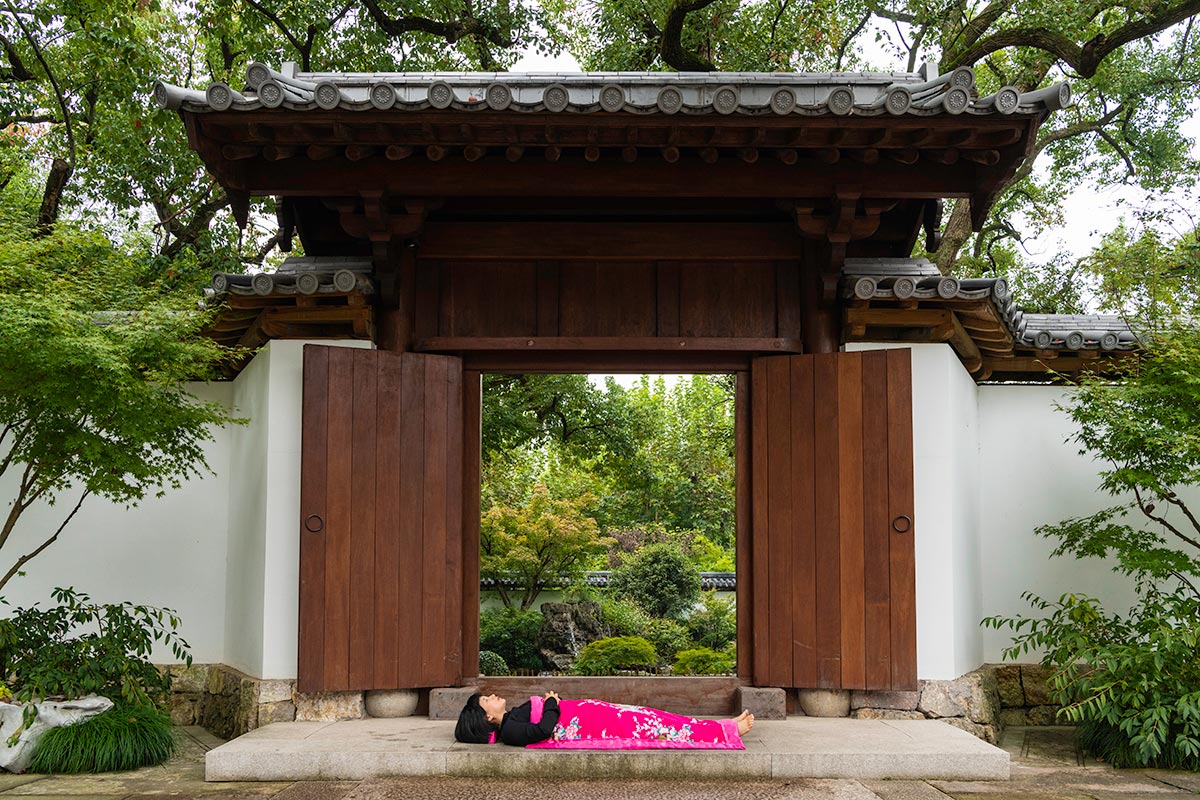 Chun Hua Catherine Dong sleeps on an old traditional gate in HangZhou, China 