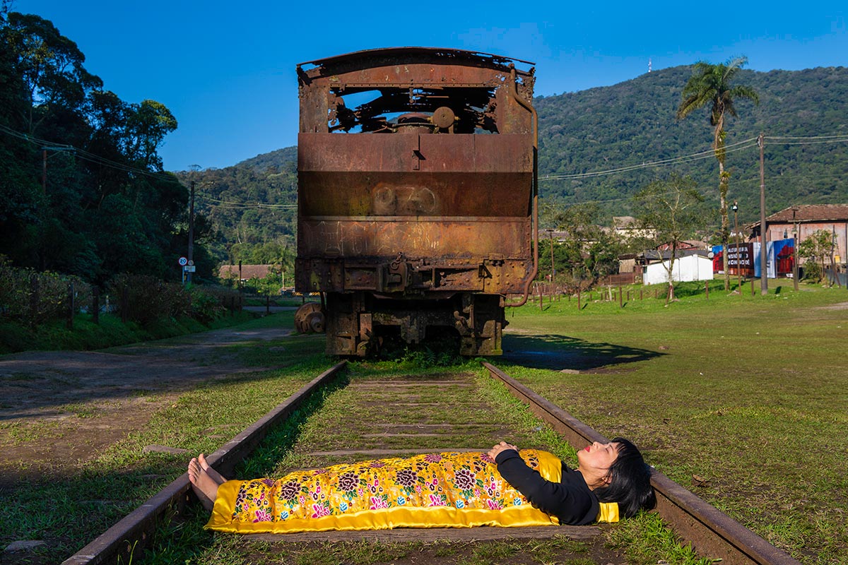 Chun Hua Catherine Dong is with an old rusty train in Sao Paulo