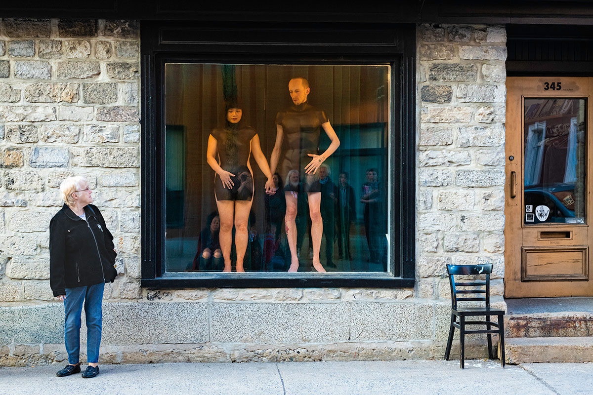 Chun Hua Catherine Dong and her performance partner wear mannequin torsos and perform on a window at Le Lieu, centre en art actuel, Quebec City 