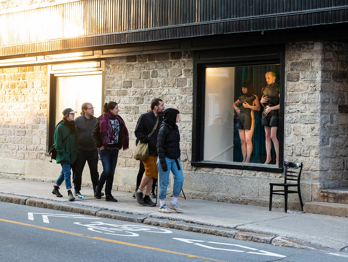 Chun Hua Catherine Dong and her performance partner wear mannequin torsos and perform on a window at Le Lieu, centre en art actuel, Quebec City 