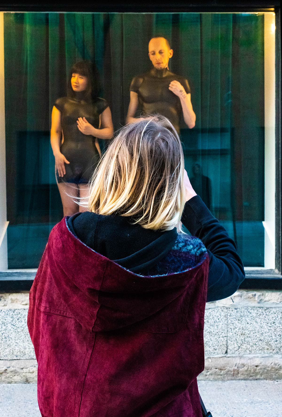 Chun Hua Catherine Dong and her performance partner wear mannequin torsos and perform on a window at Le Lieu, centre en art actuel, Quebec City 