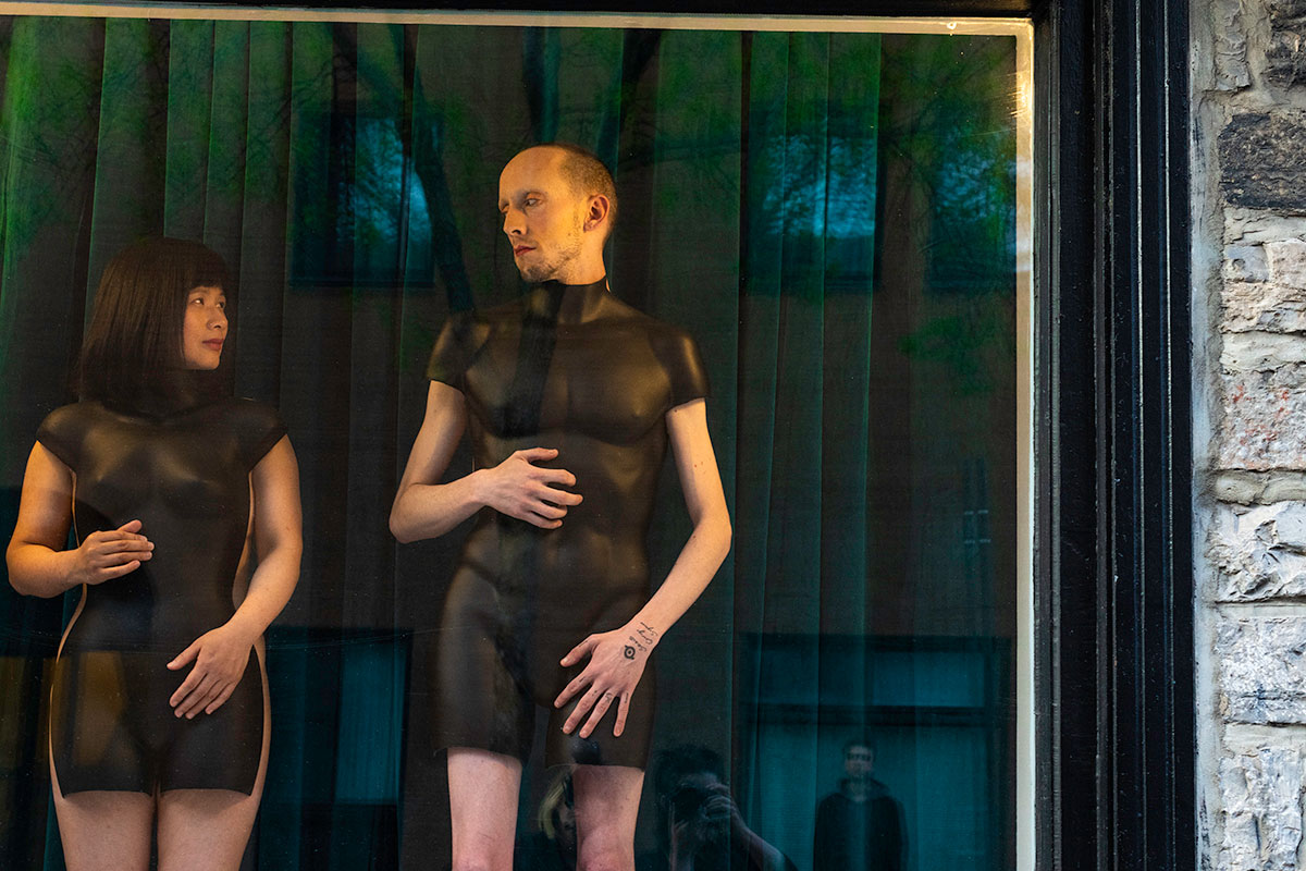 Chun Hua Catherine Dong and her performance partner wear mannequin torsos and perform on a window at Le Lieu, centre en art actuel, Quebec City 