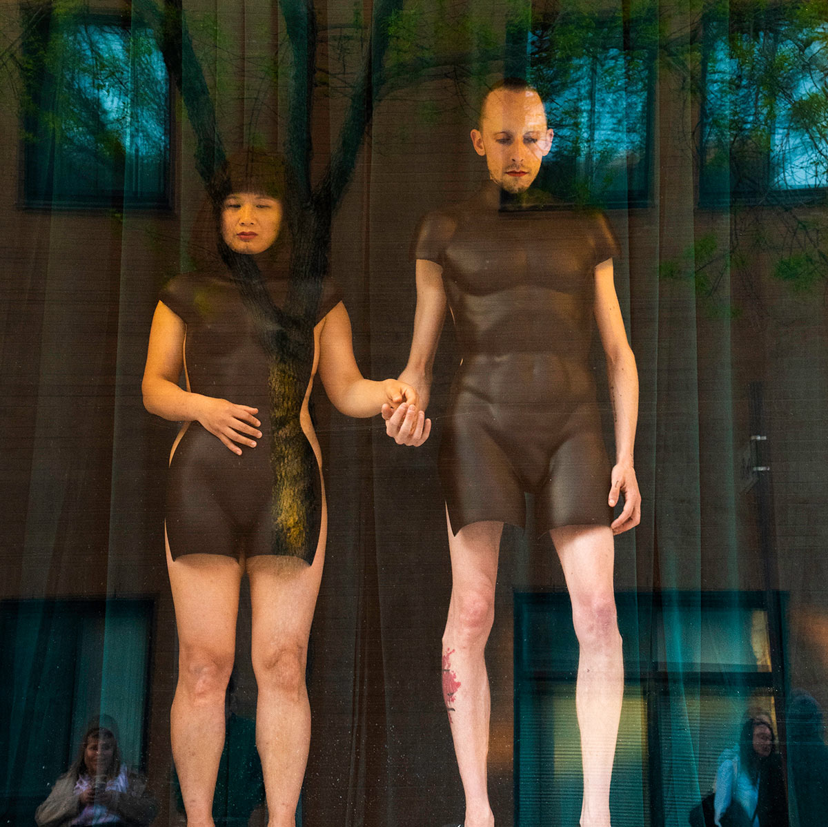 Chun Hua Catherine Dong and her performance partner wear mannequin torsos and perform on a window at Le Lieu, centre en art actuel, Quebec City 