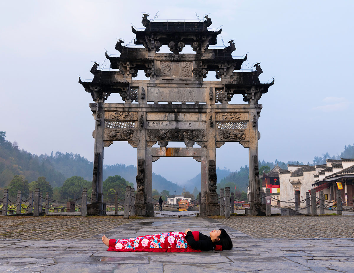 Chun Hua Catherine Dong celebrates her death and sleeps in front of famous monument in HuangSha, China