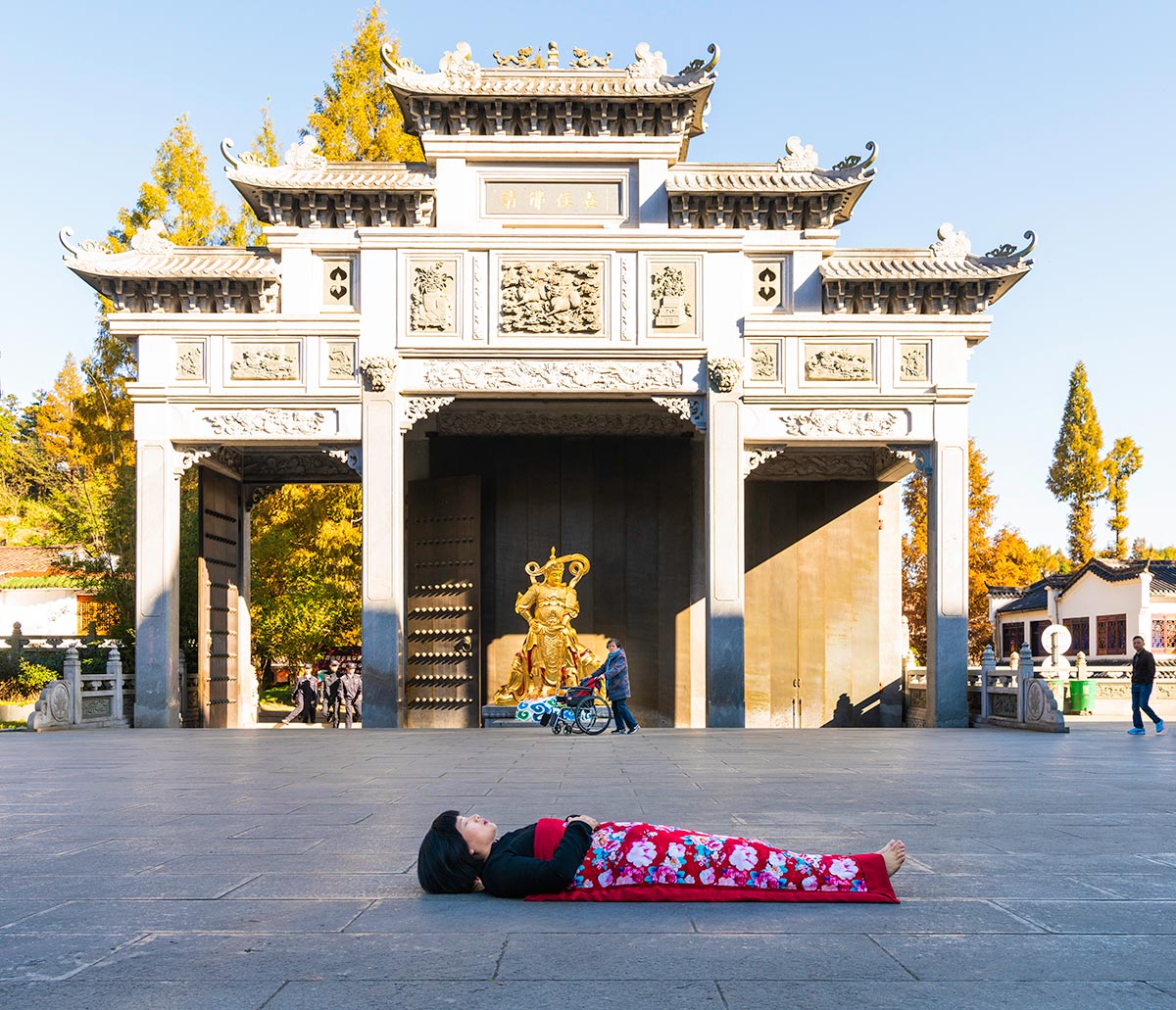 Chun Hua Catherine Dong celebrates her death and sleeps in front of a white temple in Mountain JiuHua, China