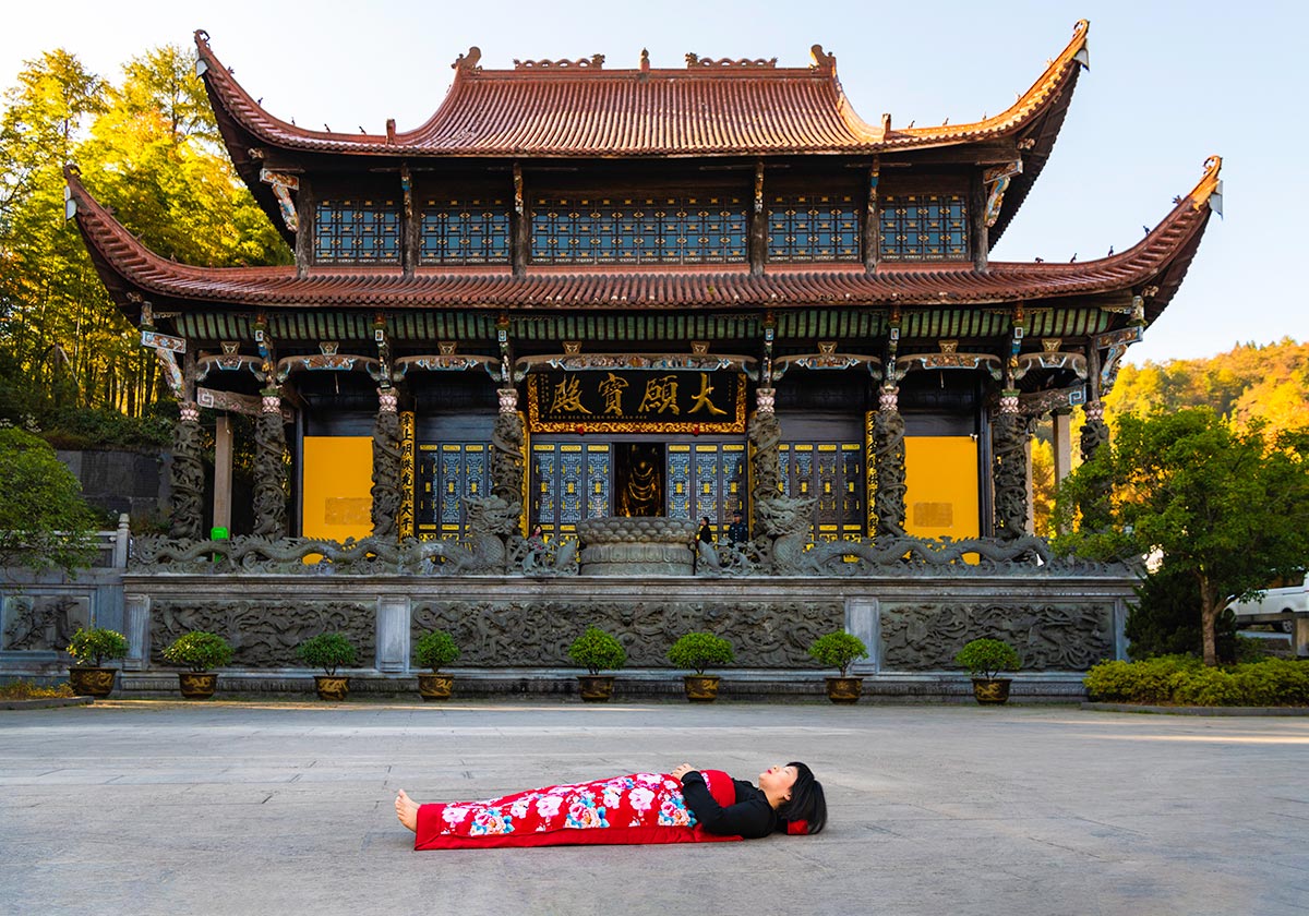 Chun Hua Catherine Dong celebrates her death and sleeps in front of  yellow temples in Mountain JiuHua, China