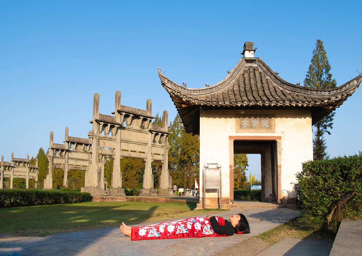 Chun Hua Catherine Dong celebrates her death and sleeps in front of old monuments in HuangSha, China