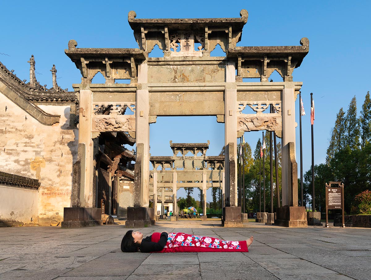 Chun Hua Catherine Dong celebrates her death and sleeps in front of old monuments in HuangSha, China