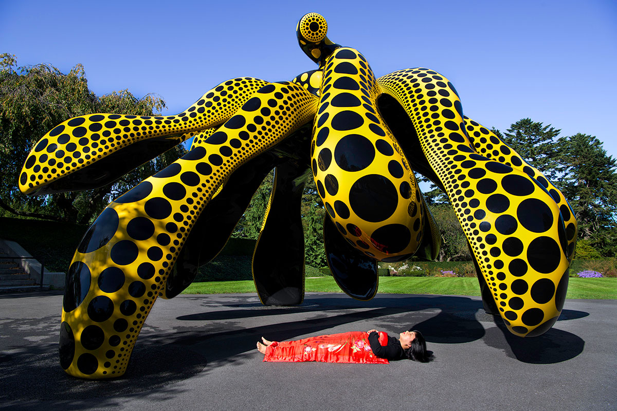 Chun Hua Catherine Dong sleeps under Kusama’s dancing pumpkin at new york botanical garden