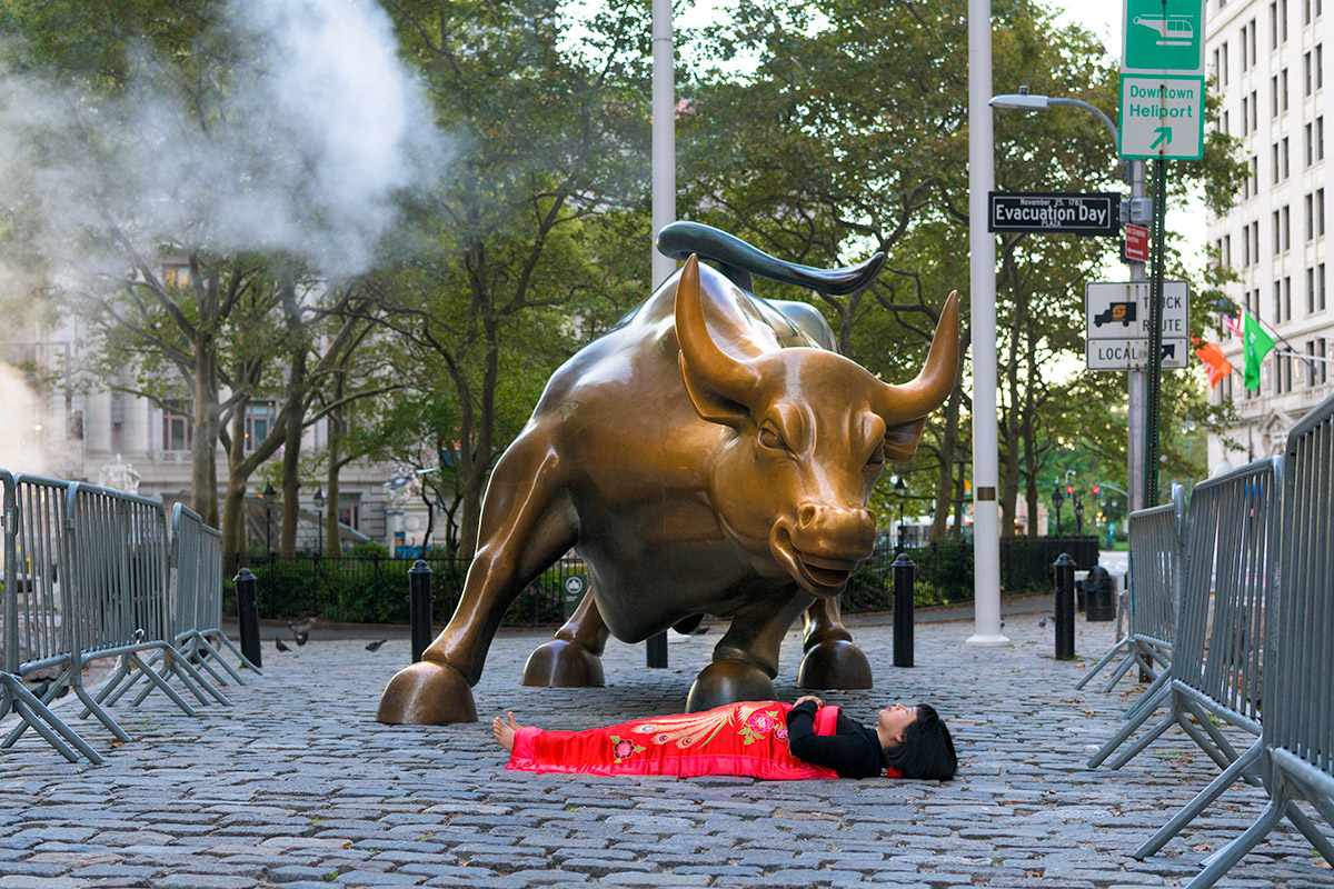 Chun Hua Catherine Dong is with the charging bull in New York City