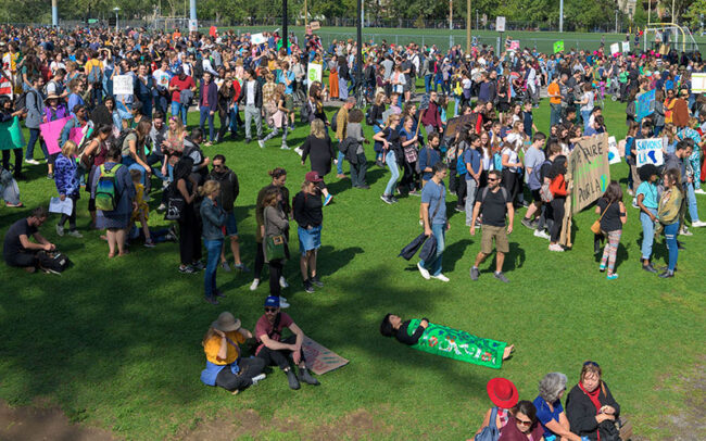 Chun Hua Catherine Dong sleeps in a park, and she was surranded by lots of people, she attended Montreal Climate March in 2019