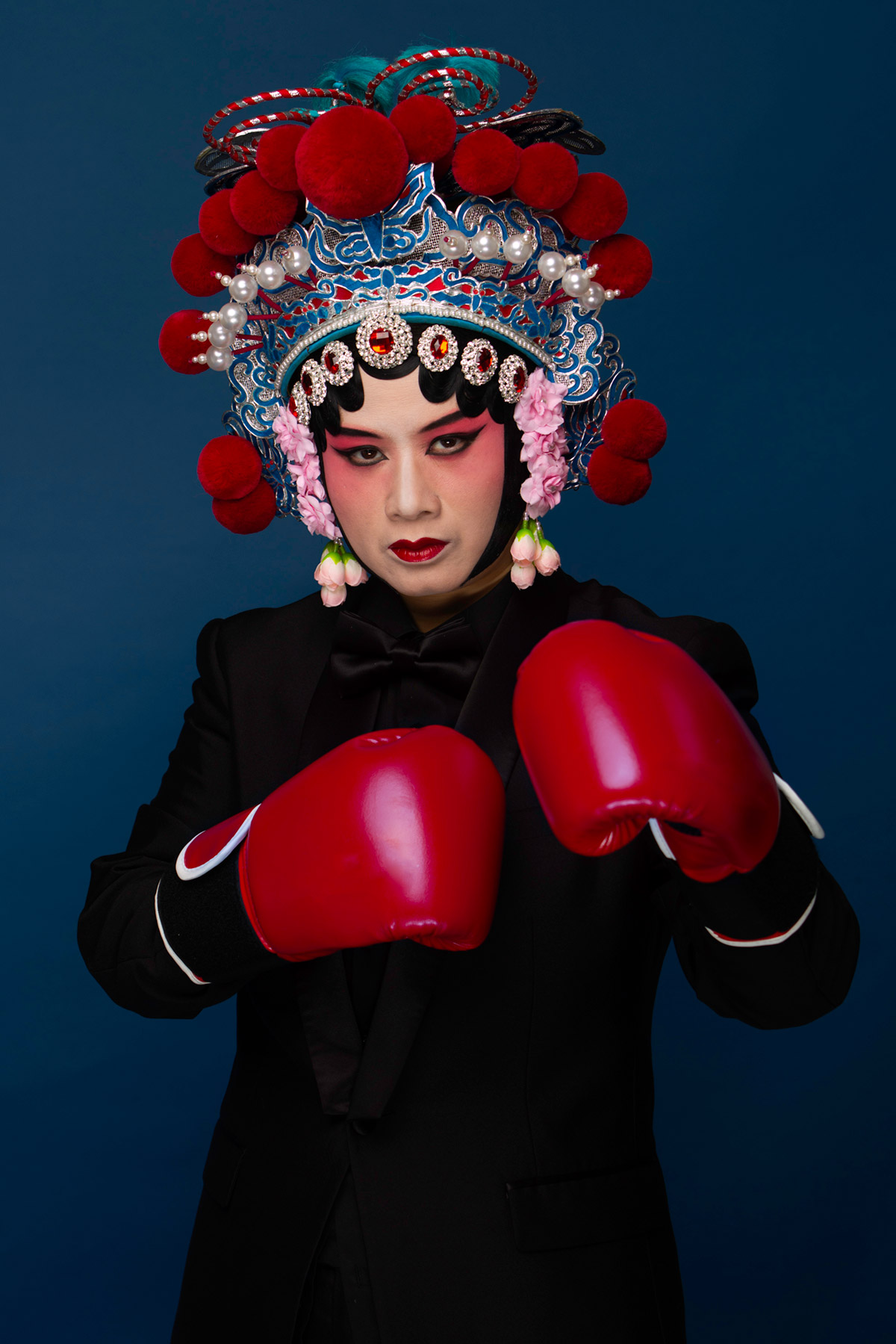 a girl wearing Beijing Opera costume with red wrestling glovess