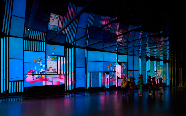 multi screen public art, a group of children watching digital screens at place des art