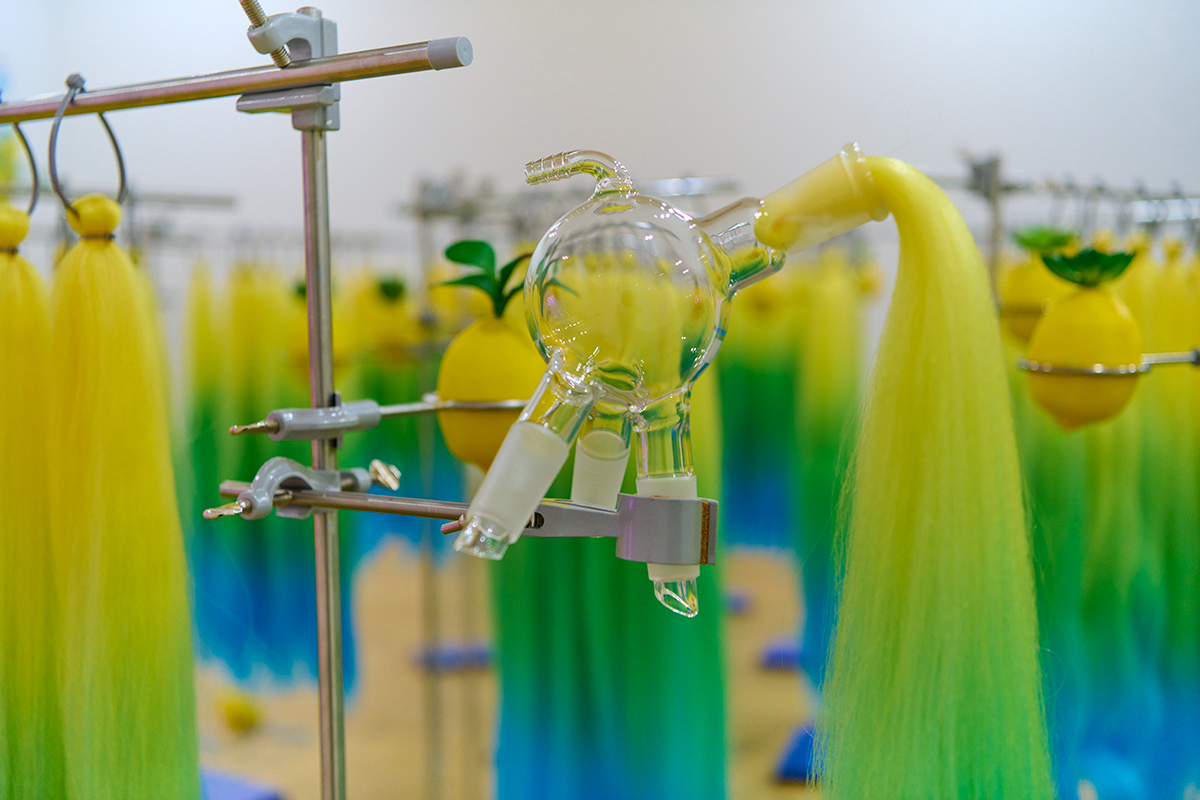 a lab glassware with bright yellow green blue hair